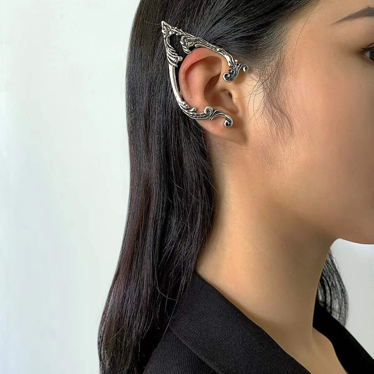 Antique silver-tone elf ear cuff worn on the right ear