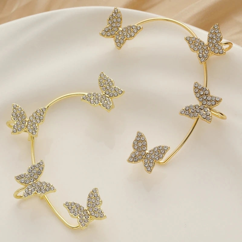 Pair of gold-tone multi-butterfly ear wraps with clear stone details