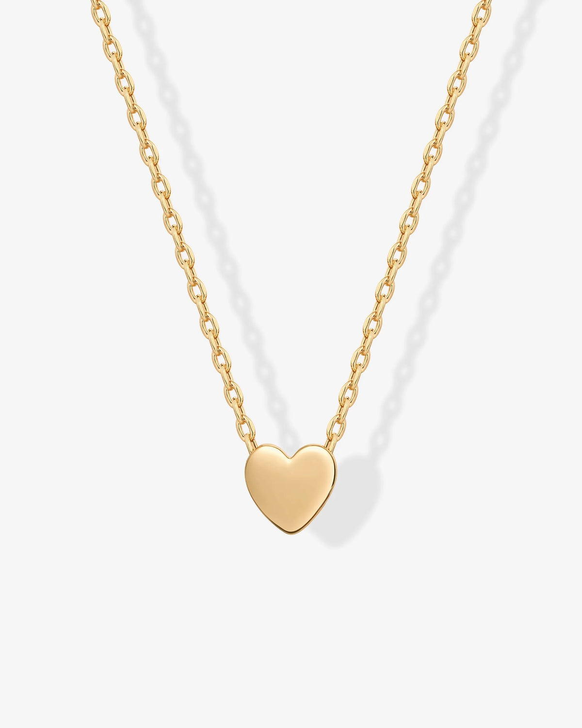 Close-up of a gold-tone heart pendant on a fine chain (PAVOI reference image; supplier appearance awaits verification)