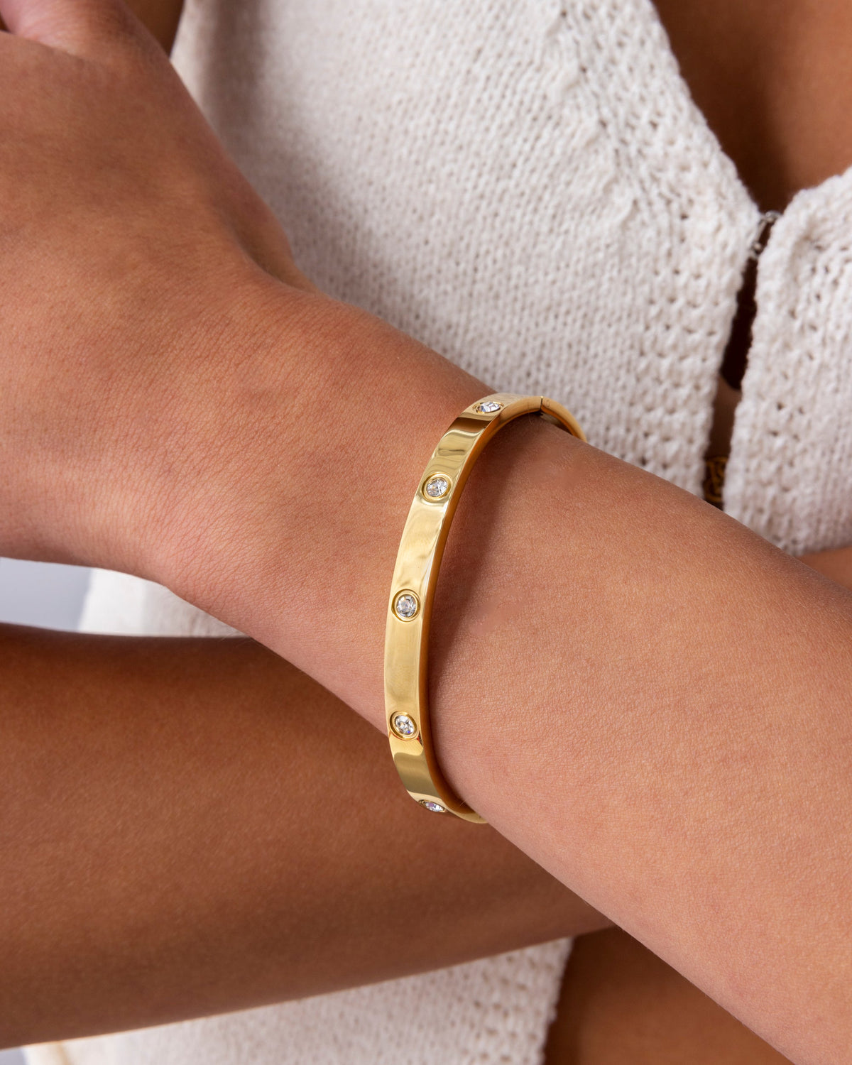 A gold-tone round-stone bangle bracelet worn on a wrist (PAVOI reference image; supplier appearance awaits verification)