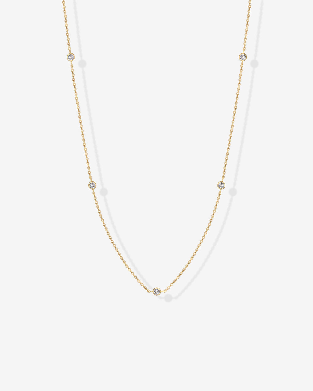 A gold-tone station necklace with round clear stones displayed on a white surface (PAVOI reference image; supplier appearance awaits verification)