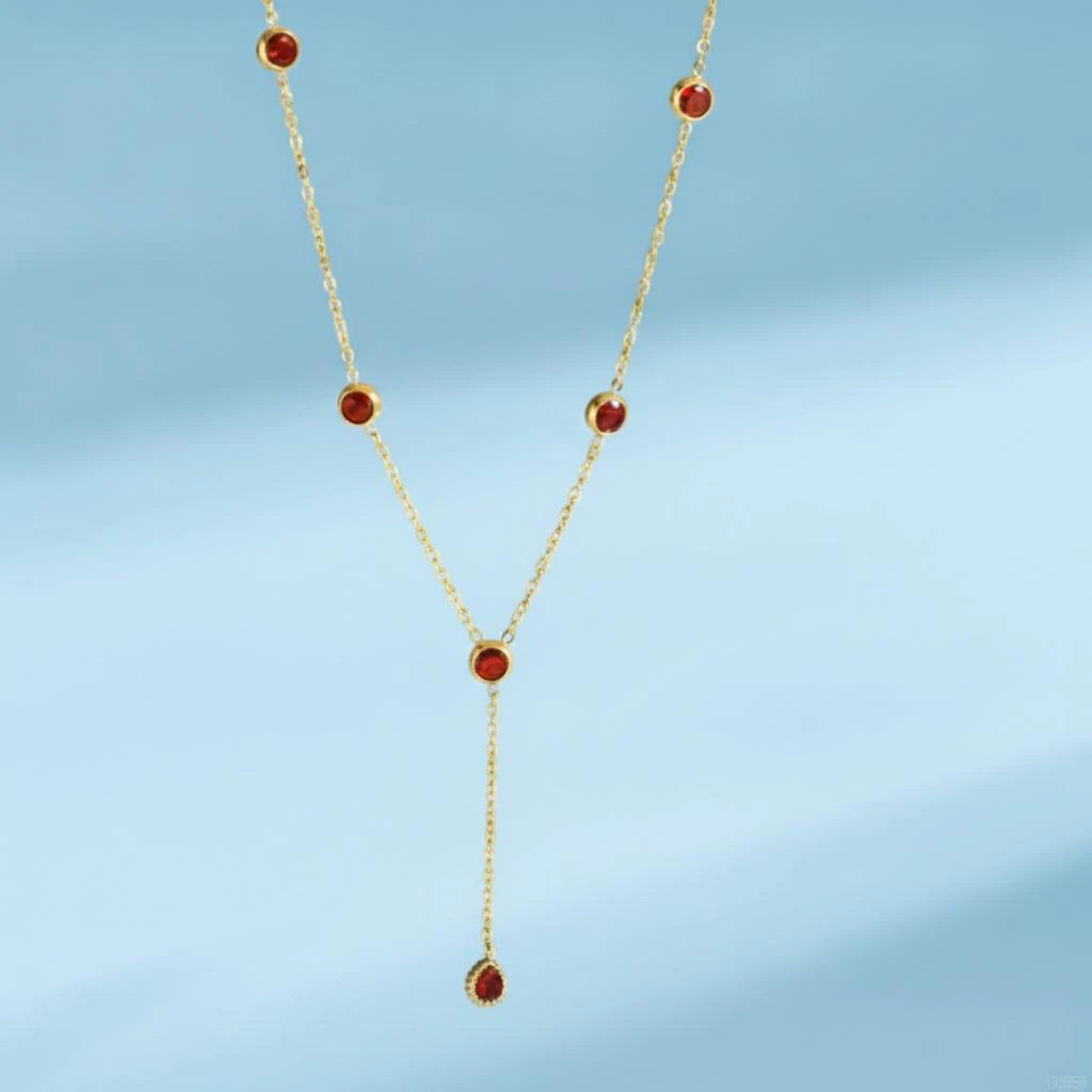 Gold-tone Y-necklace with red round stones and a teardrop pendant