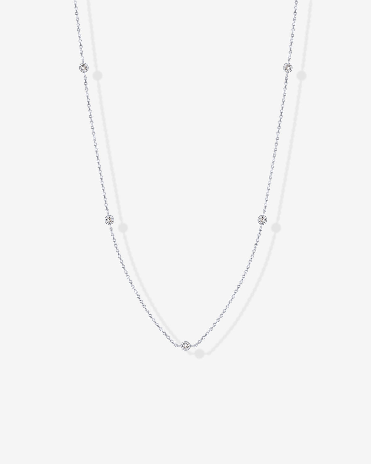 A silver-tone station necklace with round clear stones displayed on a white surface (PAVOI reference image; supplier appearance awaits verification)
